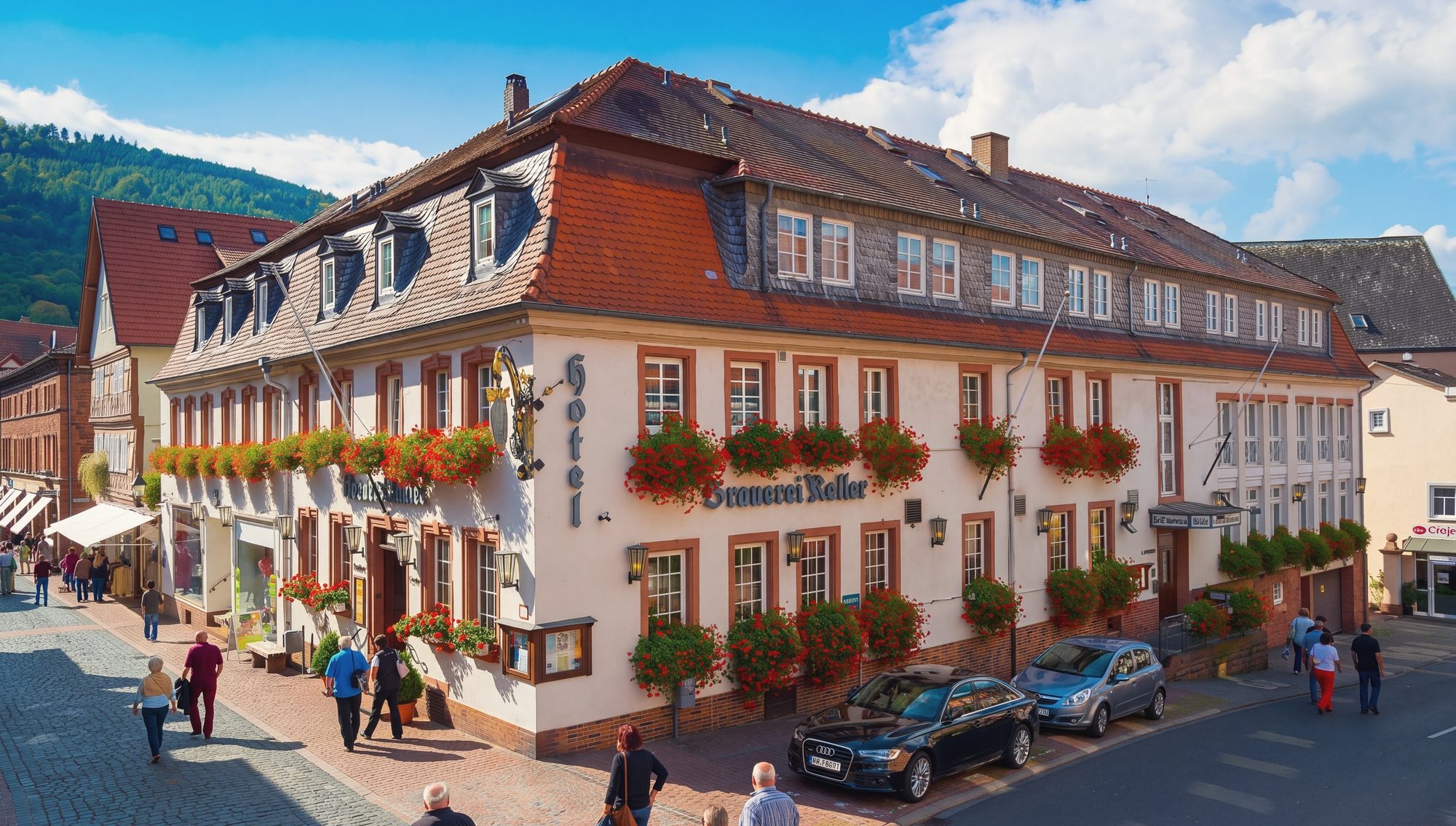 Das Hotel Brauerei Keller an der Hauptstraße in Miltenberg, Fassade mit rotem Mansarddach und Geranien an den Fenstern.